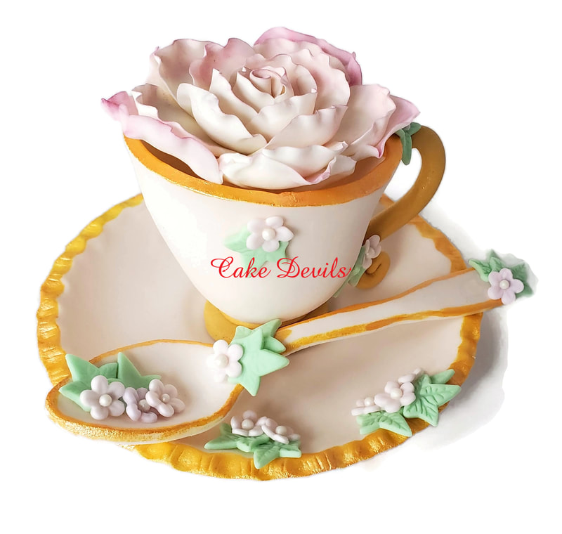 Fondant tea cup cake topper with flowers